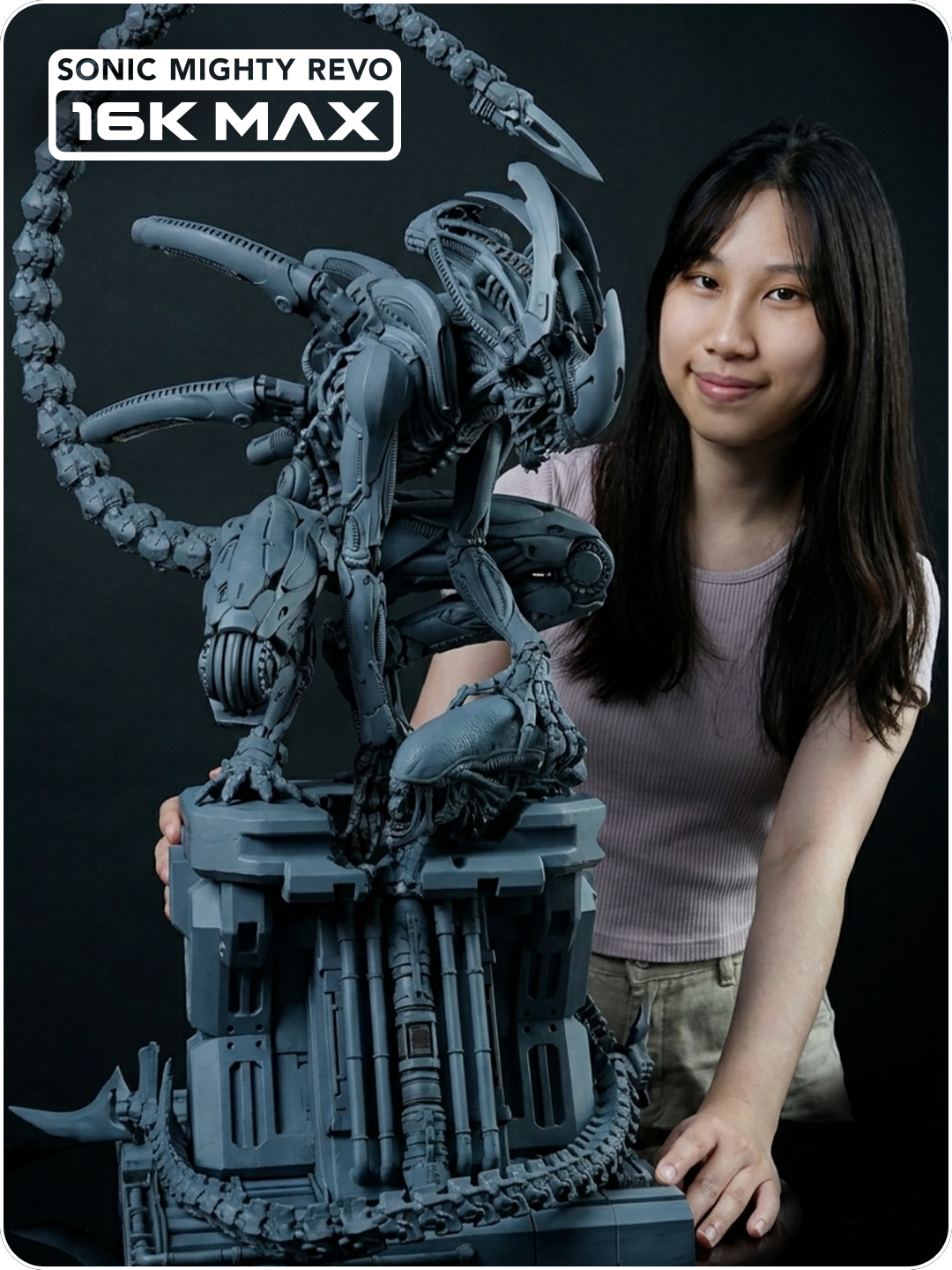 Instagram video thumbnail featuring a maker beside a large gray biomechanical creature sculpture with an arched tail, printed with Revo MAX.